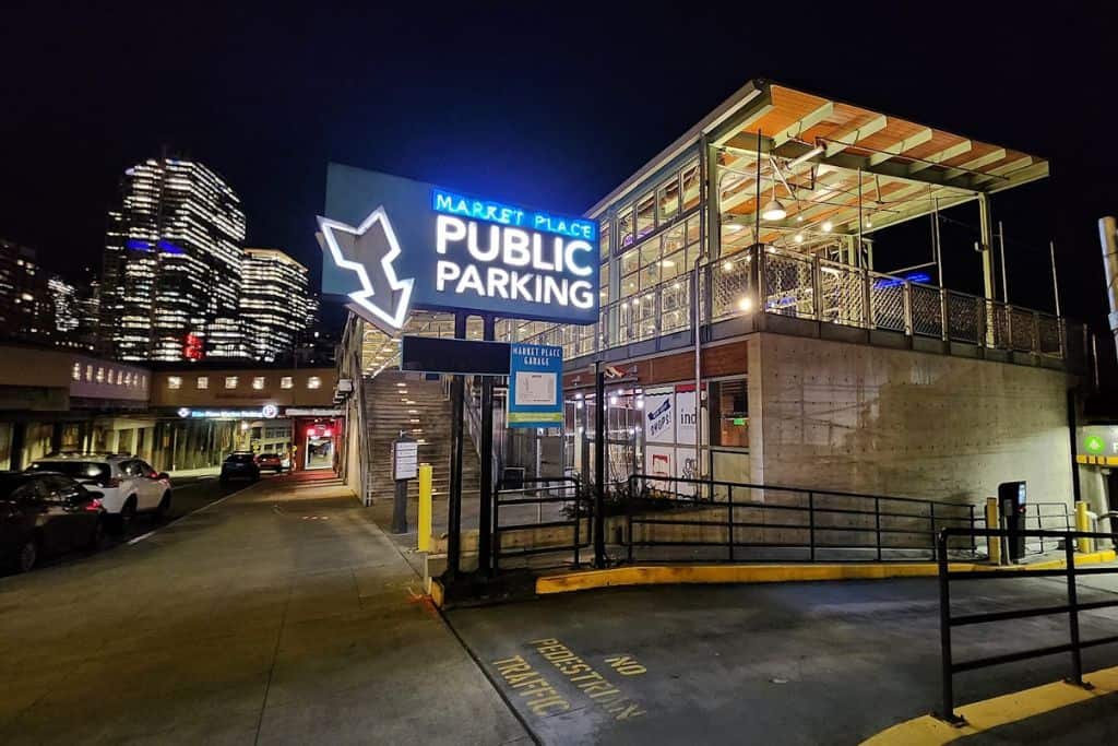 Evening shot of skyscrapers with illuminated "Market Place Public Parking" sign