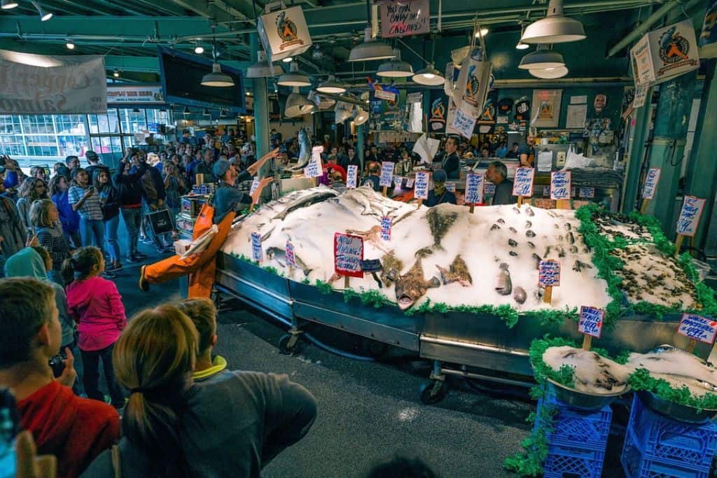 Busy indoor market with fish and seafood on ice