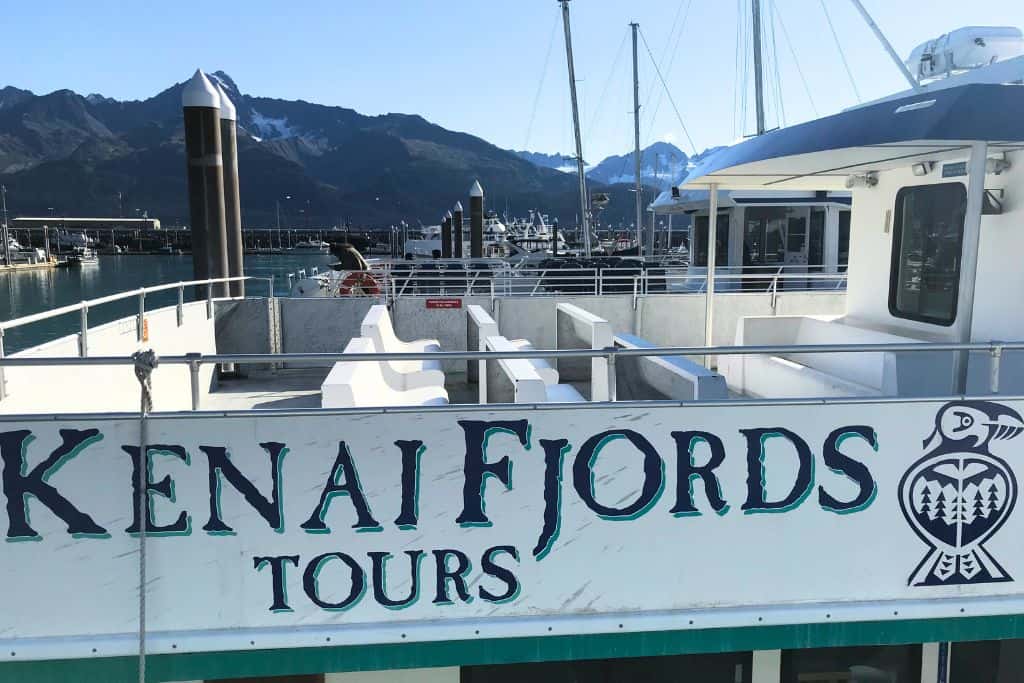 Side view of the top deck of a boat labeled as "Kenai Fjords Tours"