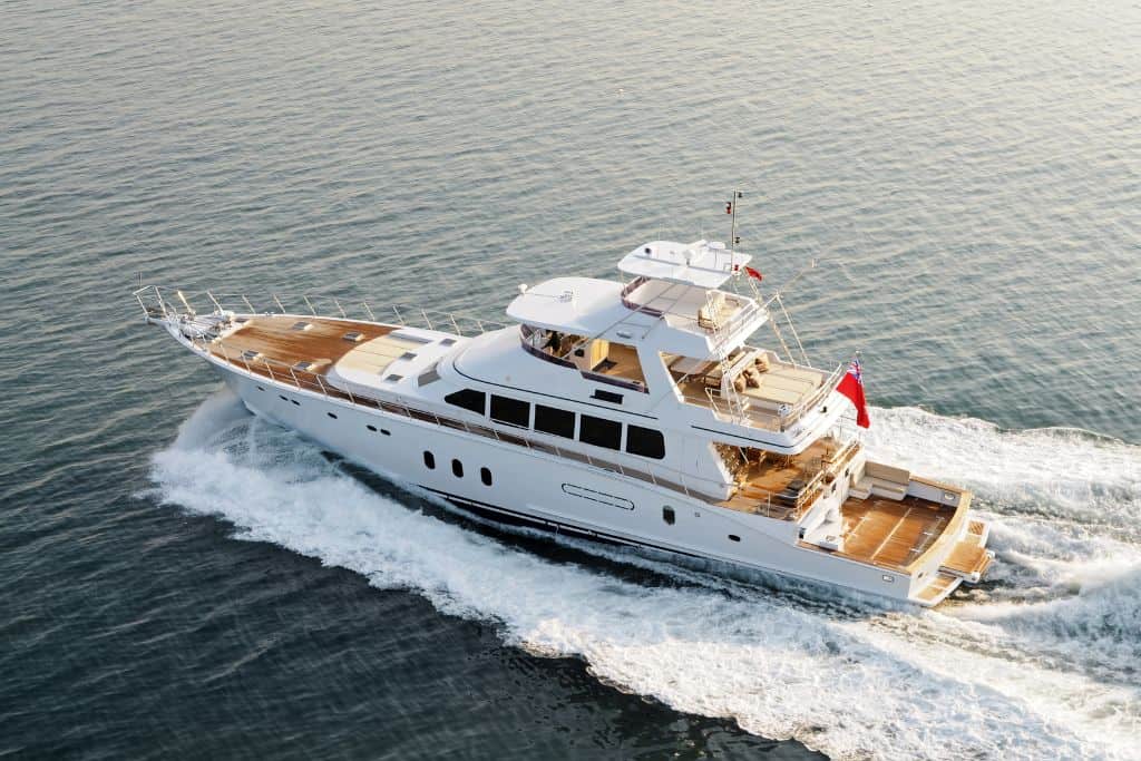 Large white yacht sailing through the ocean