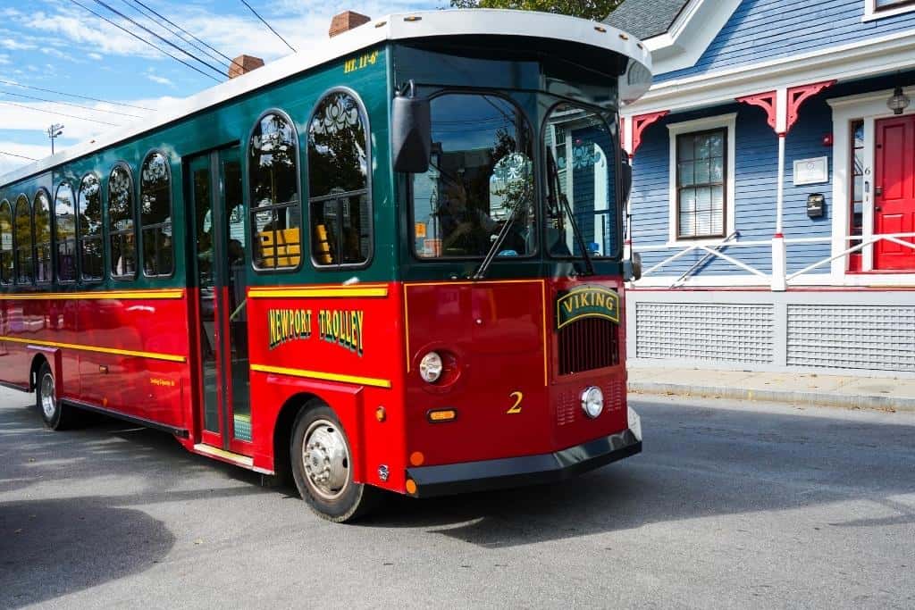 Red and green Newport Trolley driving down the street
