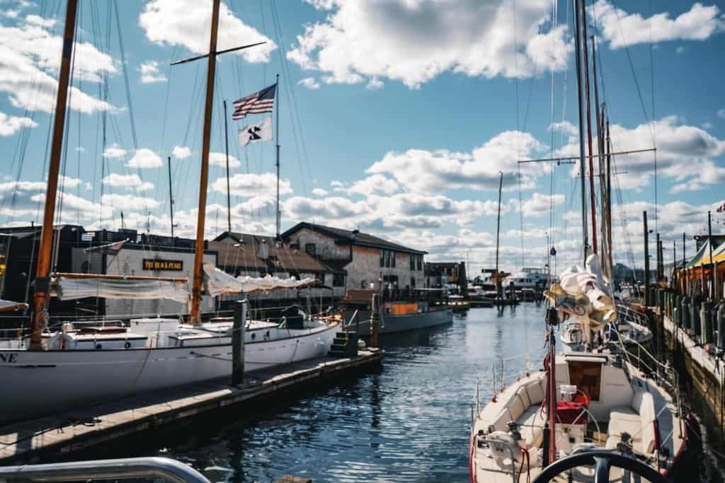 Wide harbor with sailboats and a flying American flag