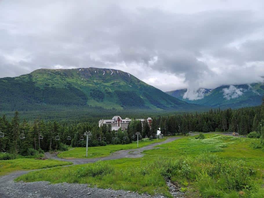 Lush, green and blue mountains with a distant resort