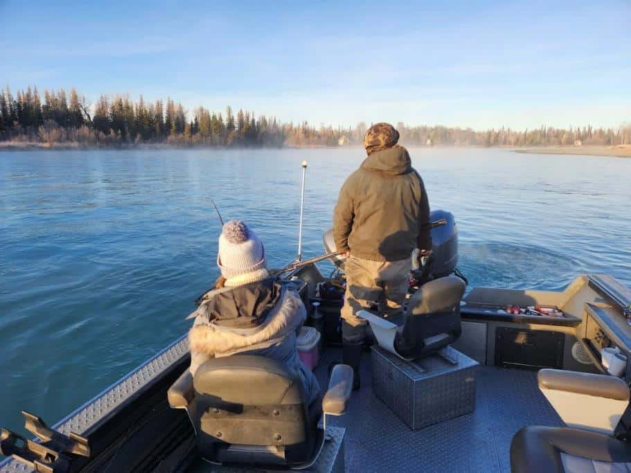 Man and woman in a small fishing boat on a river