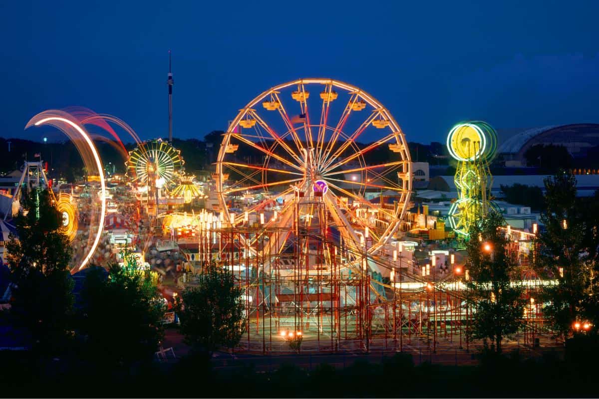 Illuminated night shot of a festival with a ferris wheel