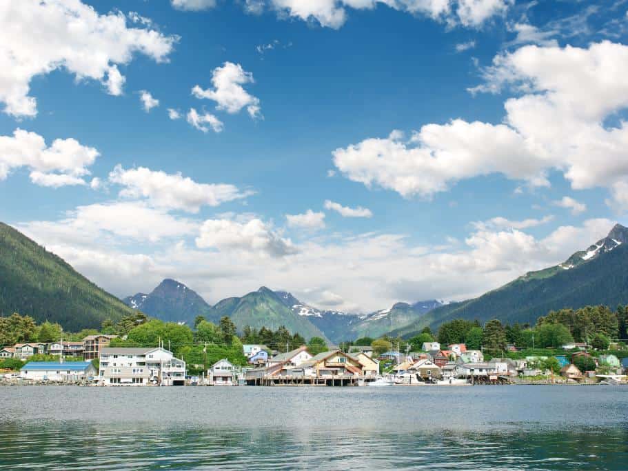 Small coastal town surrounded by lush, green mountains