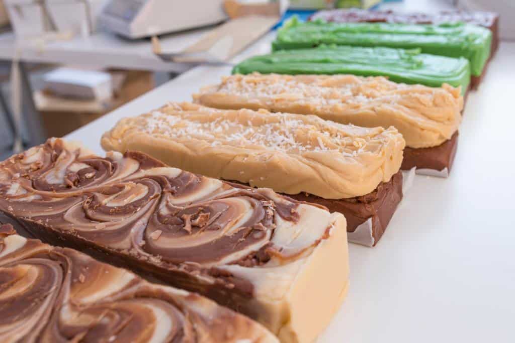 A variety of fudge in a line in different shades of green and brown