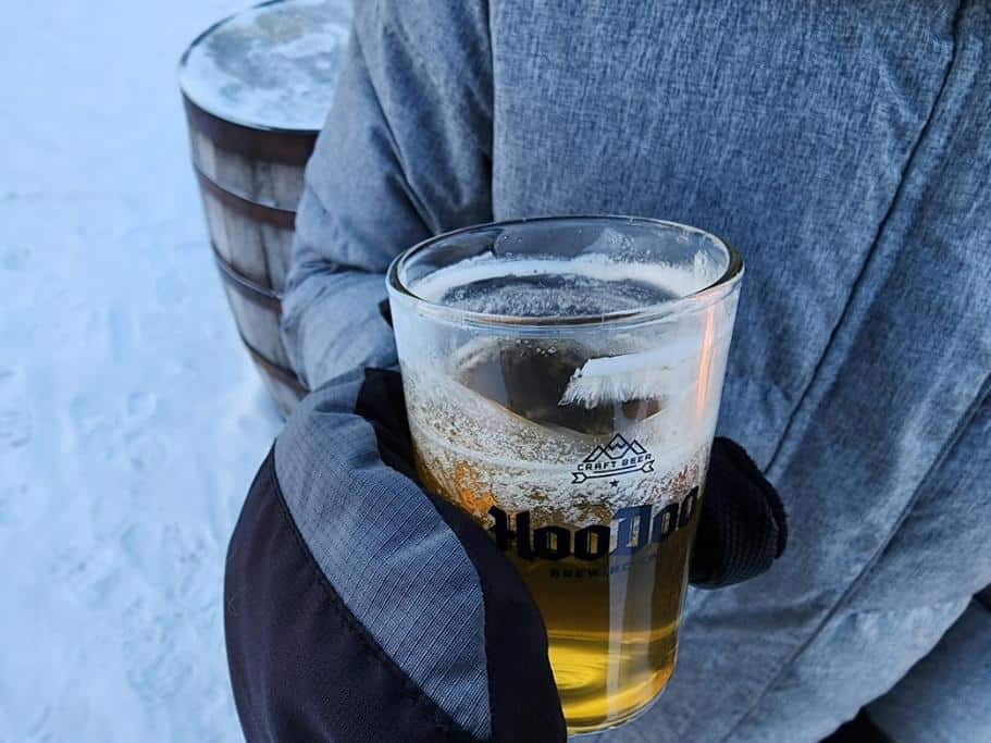 Someone holding a partially frozen beverage outdoors
