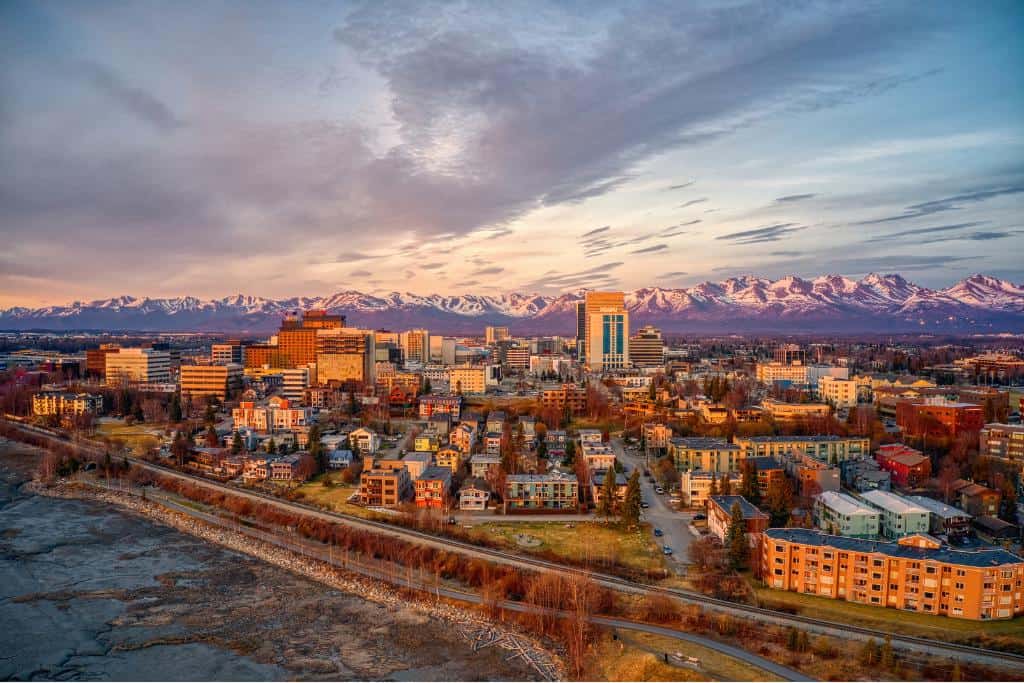 Coastline view of anchorage at sunset with a panorama of mountains in the background