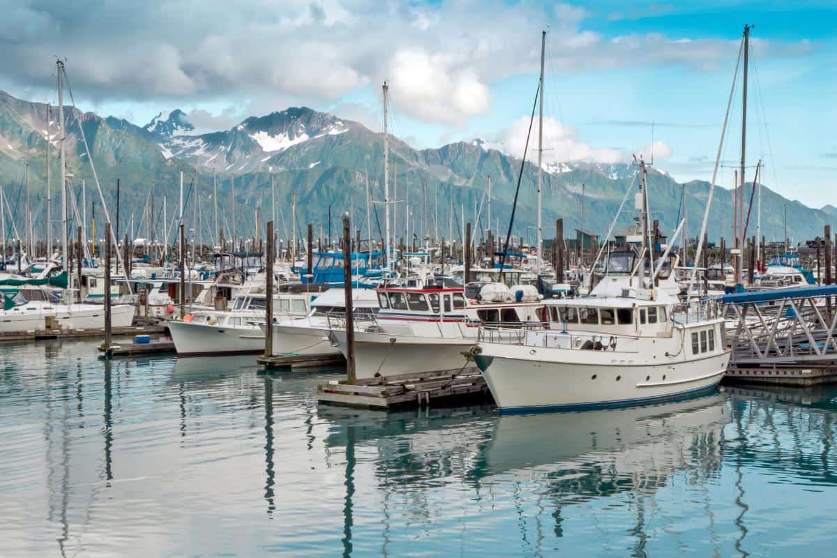 A small boat harbor with mountains in the background