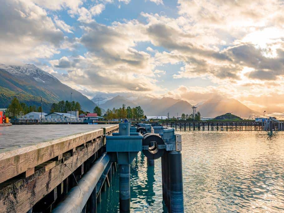 Distant mountains at sunset on a harbor with a large wooden dock