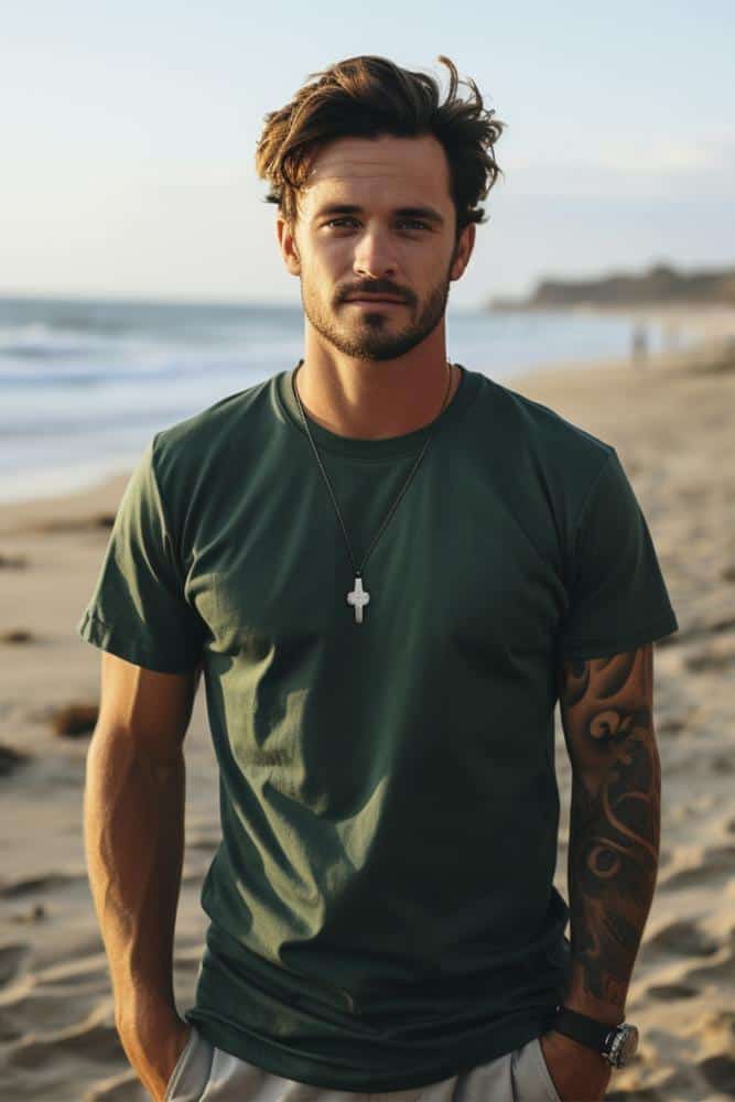 Man in green t-shirt with a necklace on the beach