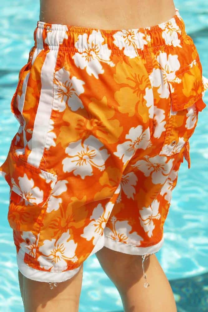 Orange and white flower mens bathing suit bottoms