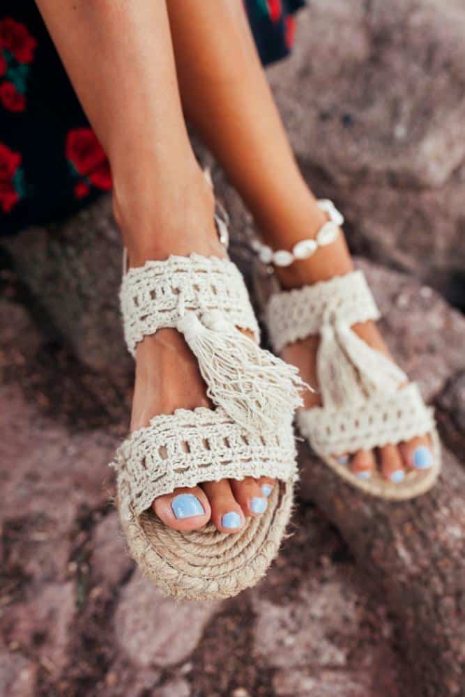 Cloth sandals on someone with blue toe nails