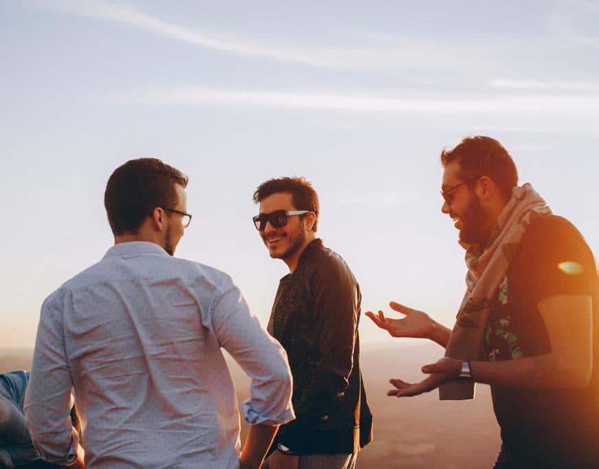 3 men in sunglasses at sunset