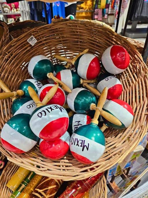 Wicker basket of red, white, and green maracas with "Mexico" written on them