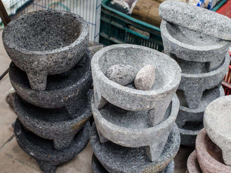 Four stacks of grey mortar and pestles