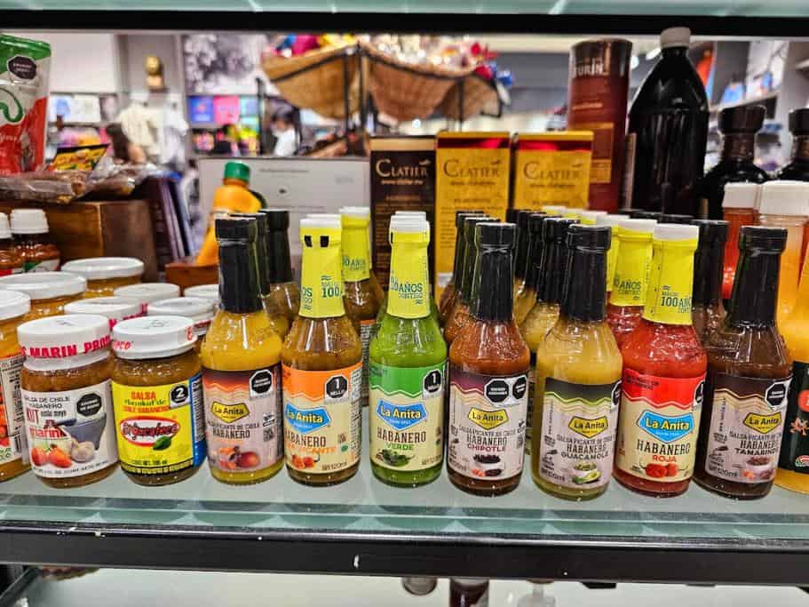 Glass shelf of a variety of hot sauces
