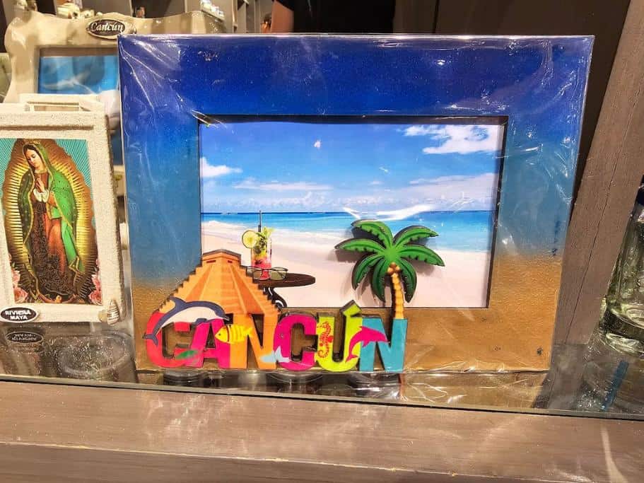 Blue and yellow picture frame with "Cancun" written in the corner