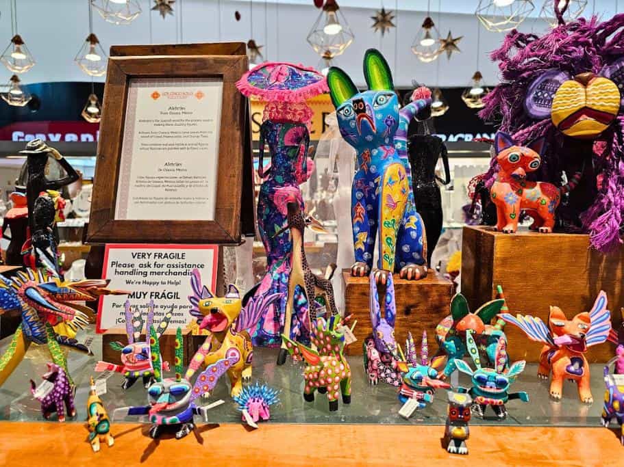 Shelf of colorful cultural creatures called alebrijes