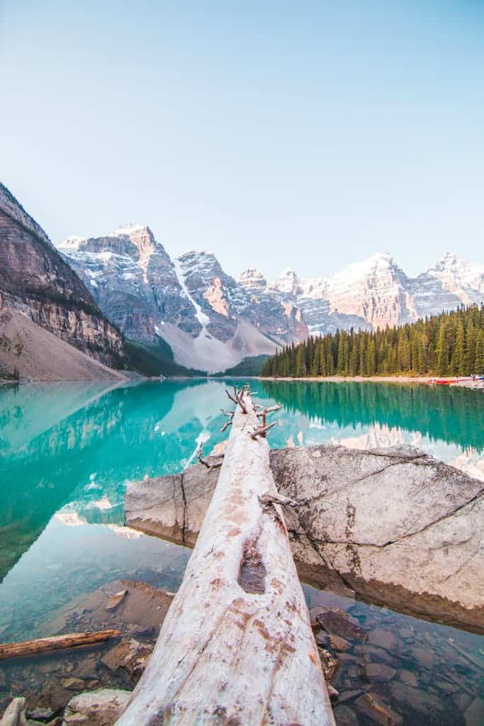 Stunning view of Moraine Lake with snowy peaks and clear turquoise waters in Banff National Park.