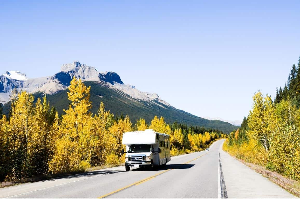 RV driving down the Icefields Parkway in the fall during foliage season